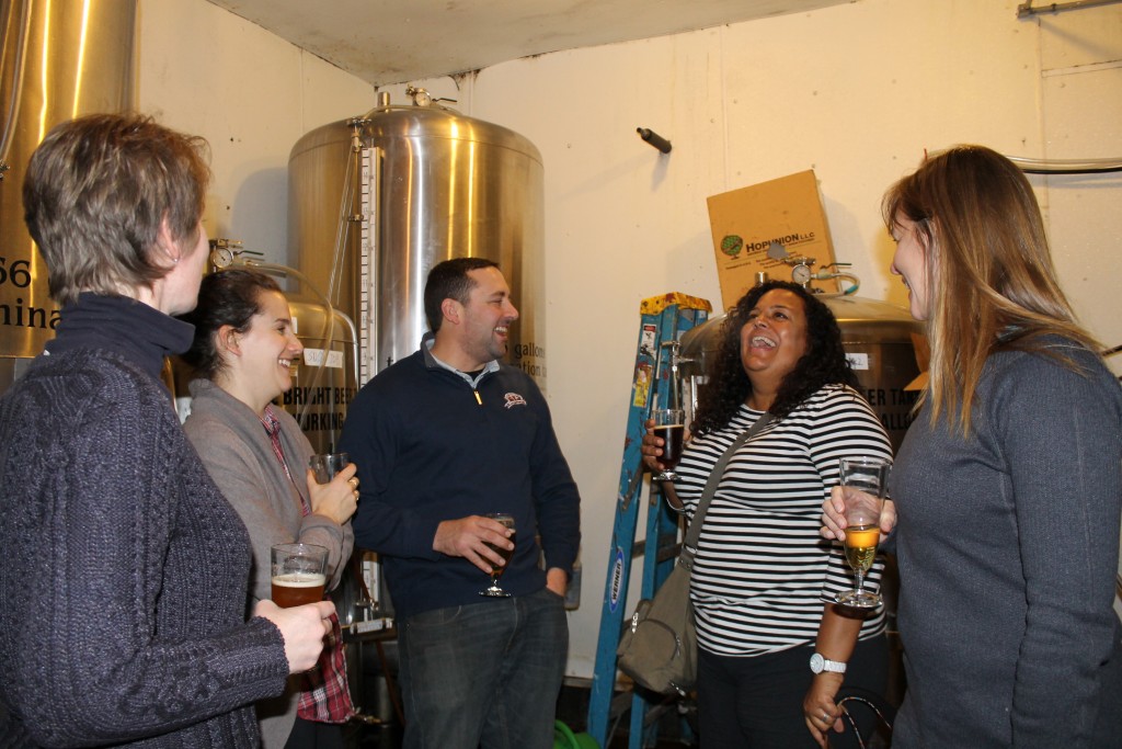 Robby Kane of Great Adirondack Brewing shows the ladies around their apparatus.