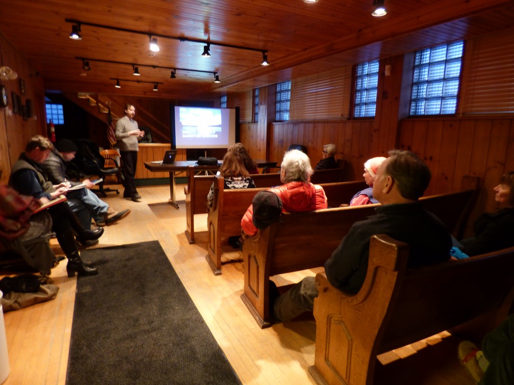 ROOST Director of Marketing Jasen Lawrence shows the Tupper Lake town board the plan for the next year. 