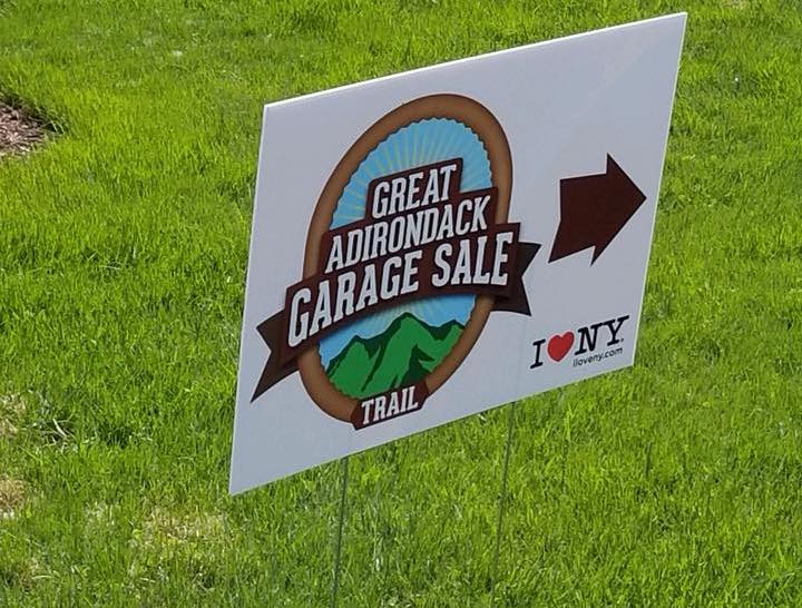 Yard sign with the Great Adirondack Garage Sale logo and arrow pointing right.