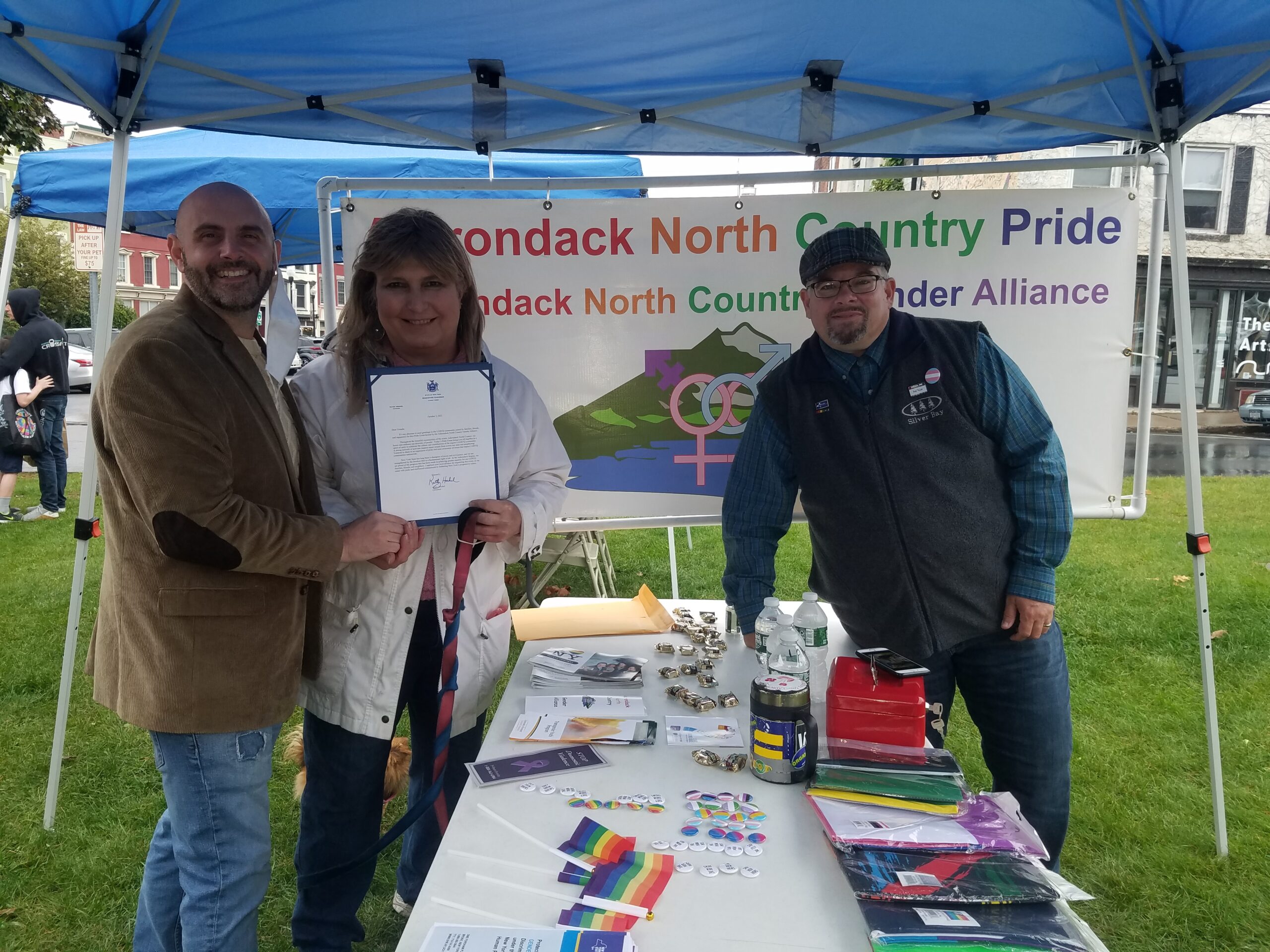 Three people posing at an outdoors event